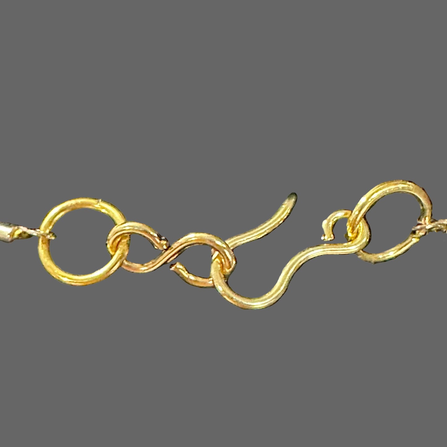 Gold bracelet on a black velvet surface