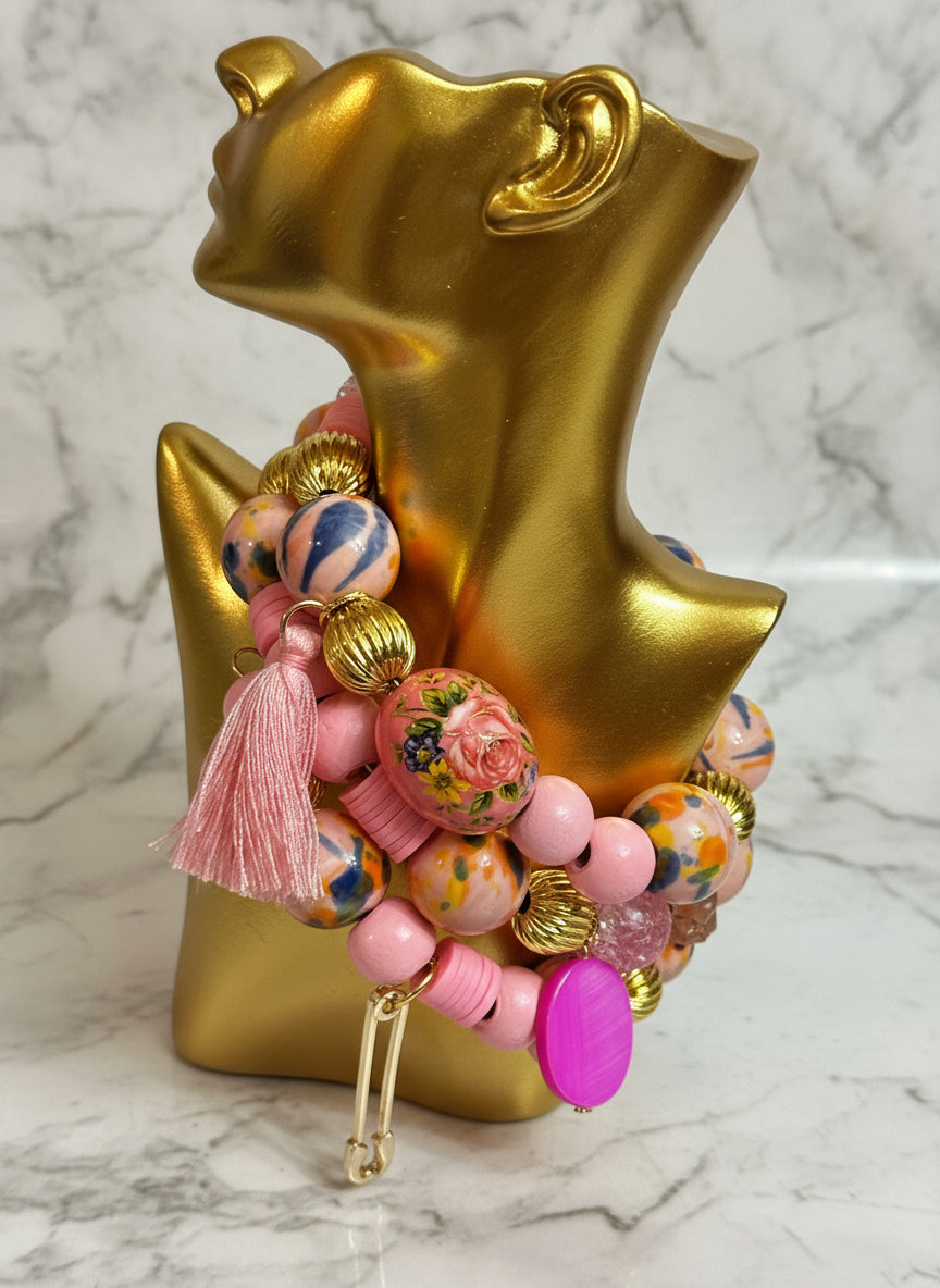 Colorful beaded keychain with tassel against a gold star-shaped object